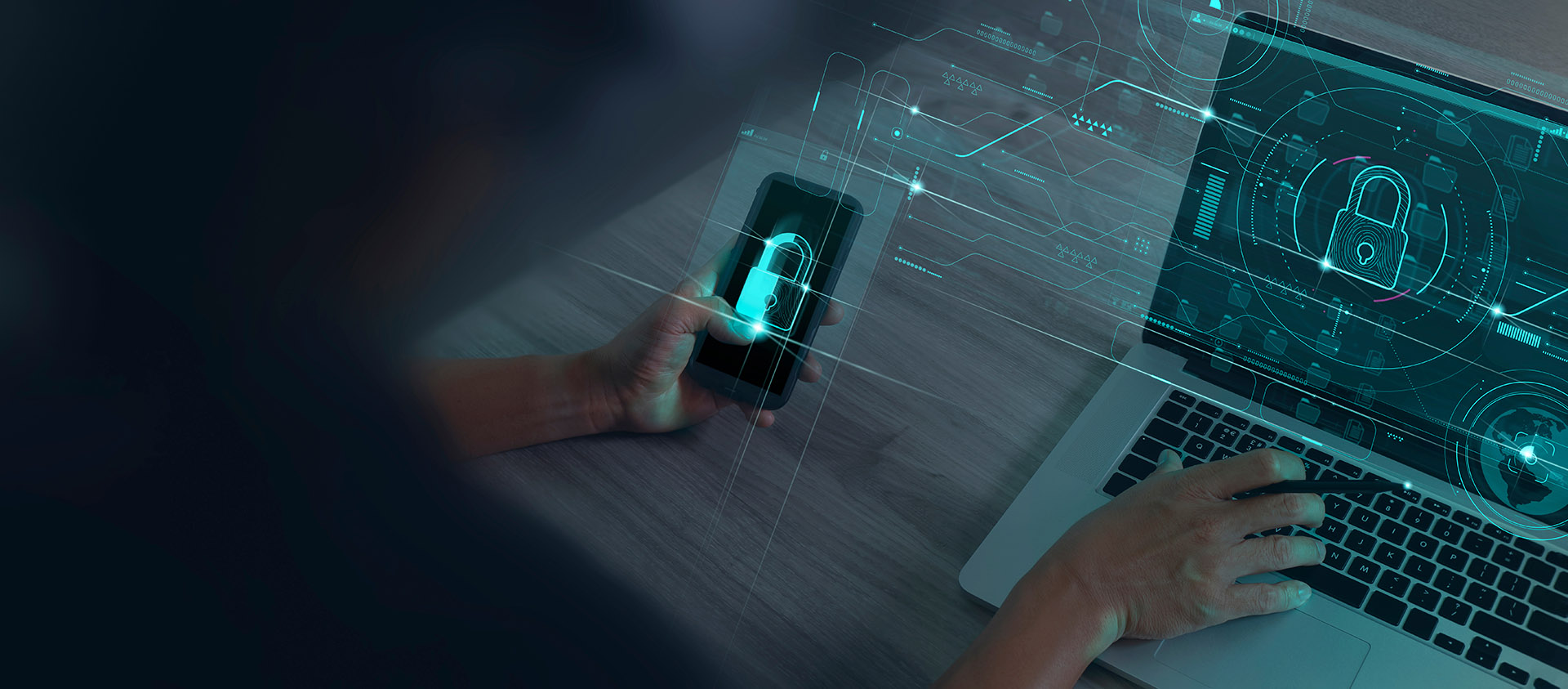 Employee holding phone and laptop using security measures